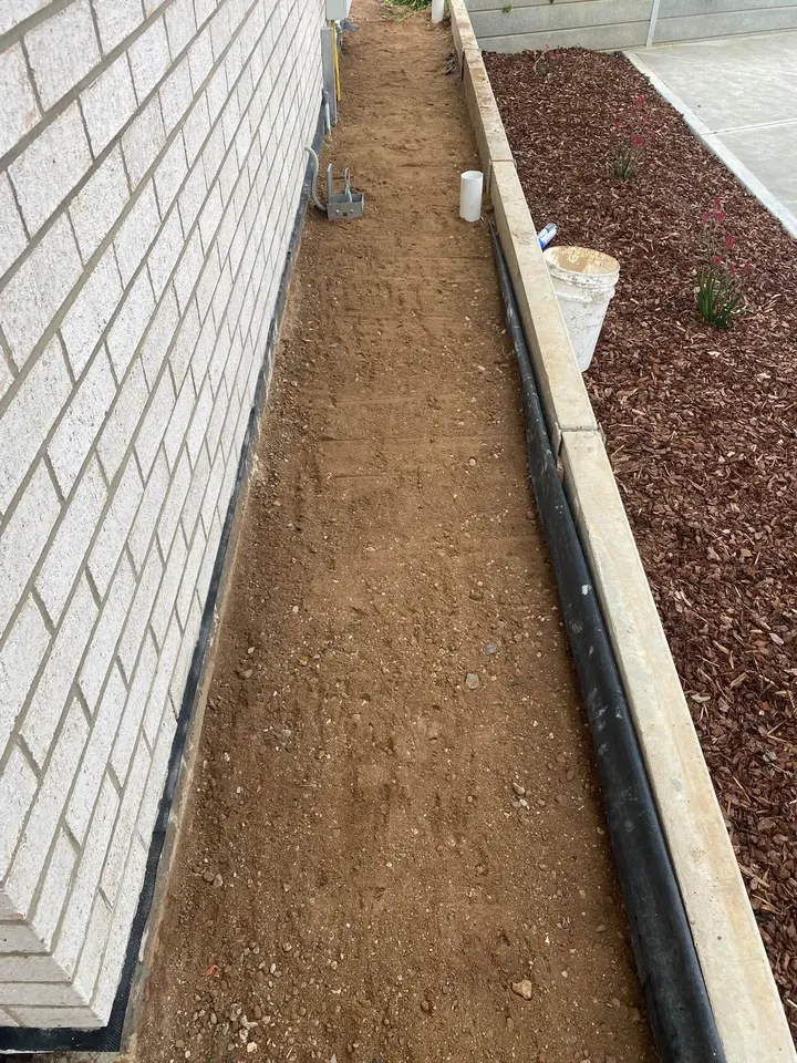 A prepped dirt path beside a garden bed